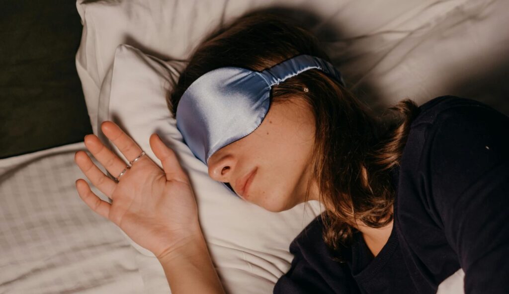 A sleep setup: eye mask, earplugs, and one familiar scent